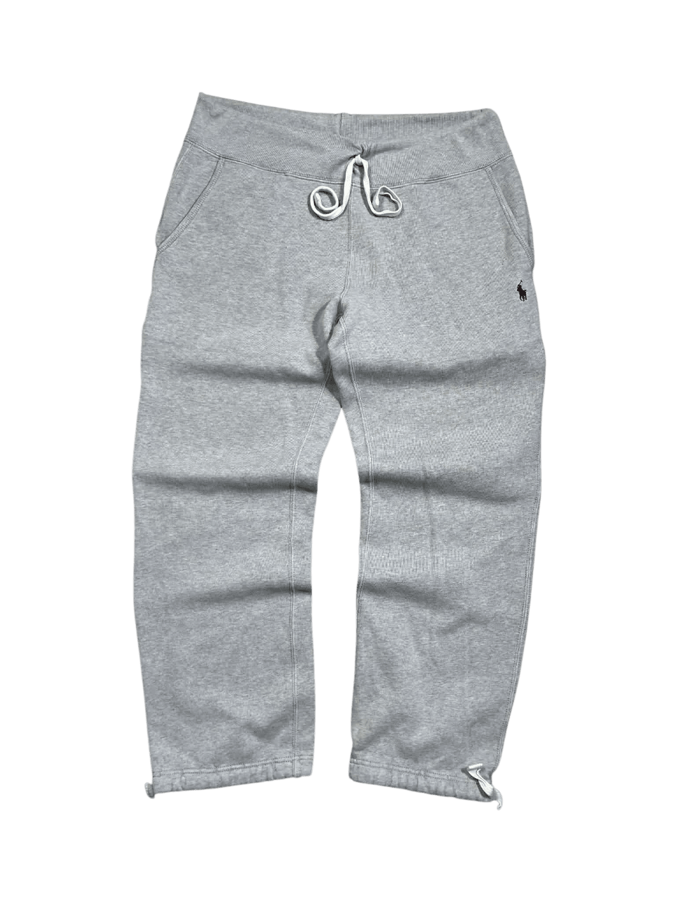 Szürke pamut jogger nadrág, zsinóros derékkal, laza streetwear stílusban.