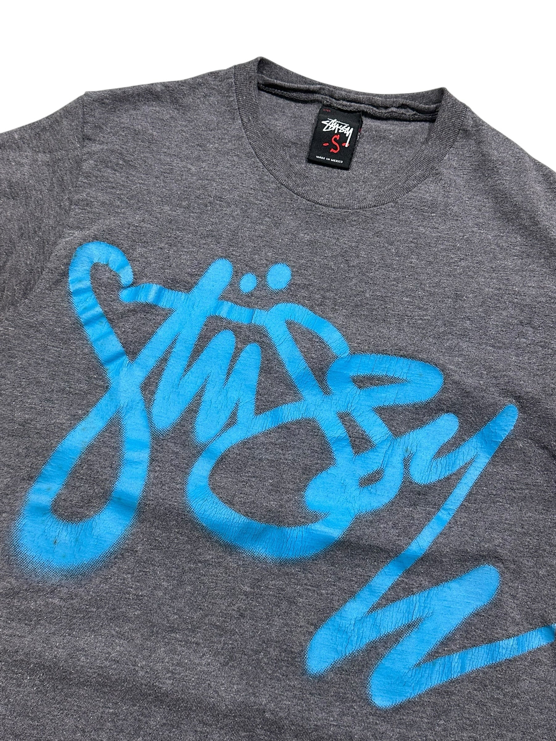 Candy Streetwear sötétszürke melírozott Stüssy póló élénk kék graffiti logóval a mellkason